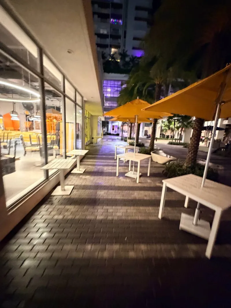 Clean commercial restaurant walkway and storefront at night